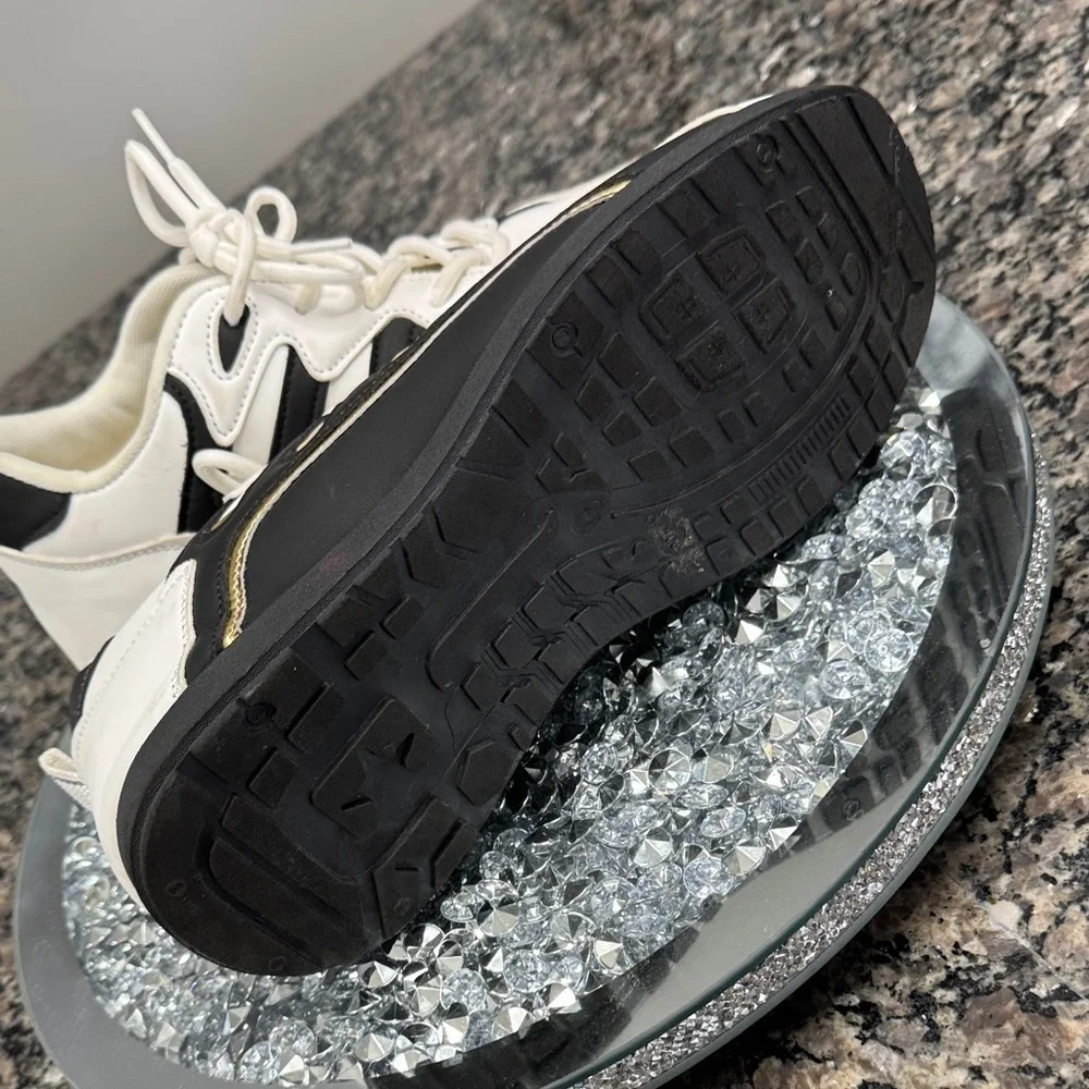 White and Black womens fashion Sneakers with gold accents EUC 10